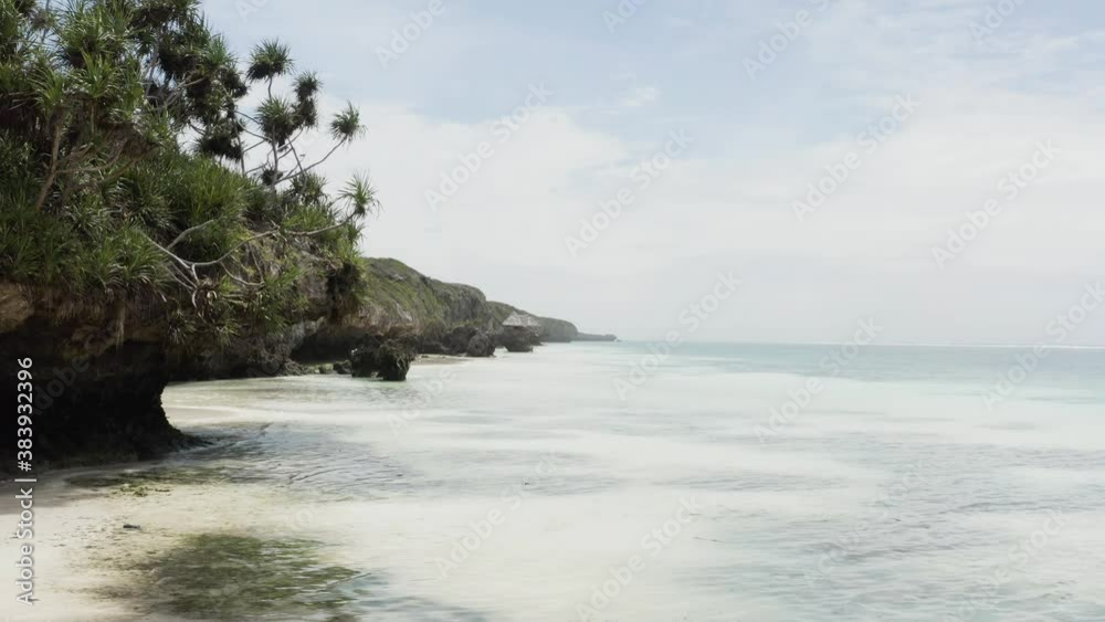 Aerial view Zanzibar Tanzania. Drone flying over the shoreline between the rocks and the blue water of the Indian Ocean with waves and corals, background landscape video.
Aerial view Zanzibar Tanzania. Drone flying over the shoreline between the rocks and the blue water of the Indian Ocean with waves and corals, background landscape video.