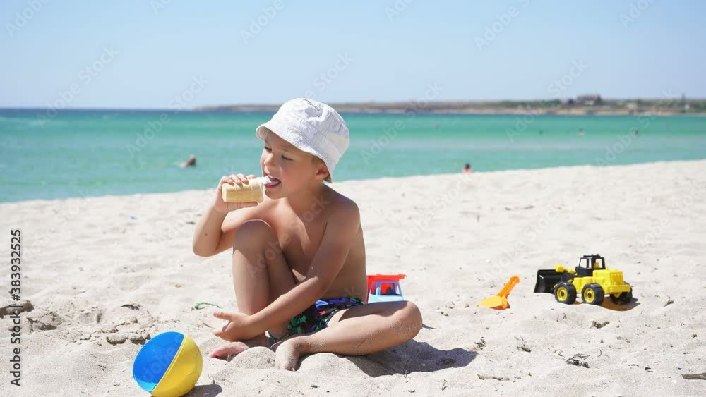 Cute child in Panama on the background of the sea eating ice cream on a Sunny summer day. Cute child in Panama on the background of the sea eating ice cream on a Sunny summer day.