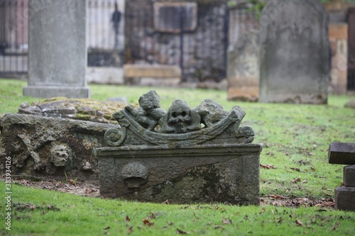Old stone grave with carved skull