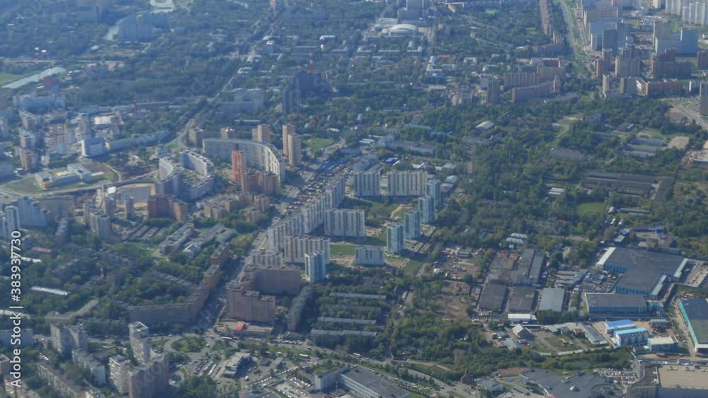 view from the window of a flying plane on a modern cityscape view from the window of a flying plane on a modern cityscape