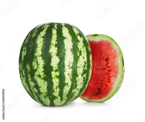 Delicious whole and cut watermelons isolated on white