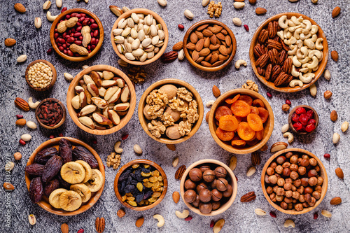 Various Nuts and dried fruits in wooden bowls.