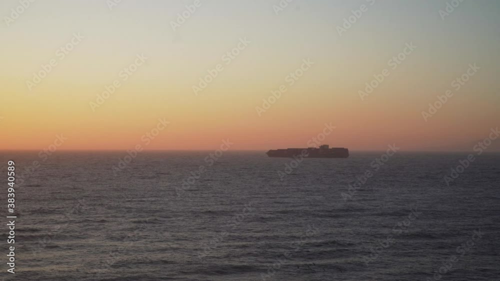Cargo Ship Sailing into the Sunset on the Pacific Ocean. Cargo Ship Sailing into the Sunset on the Pacific Ocean.