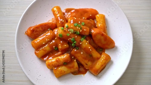 Korean rice cake stick with sausage in spicy sauce - Tteokbokki photo