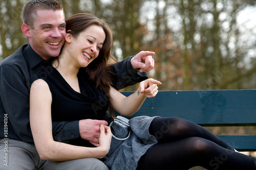 Young couple on a bench having fun