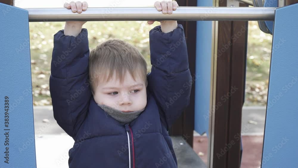 A boy walks on a playground A boy walks on a playground