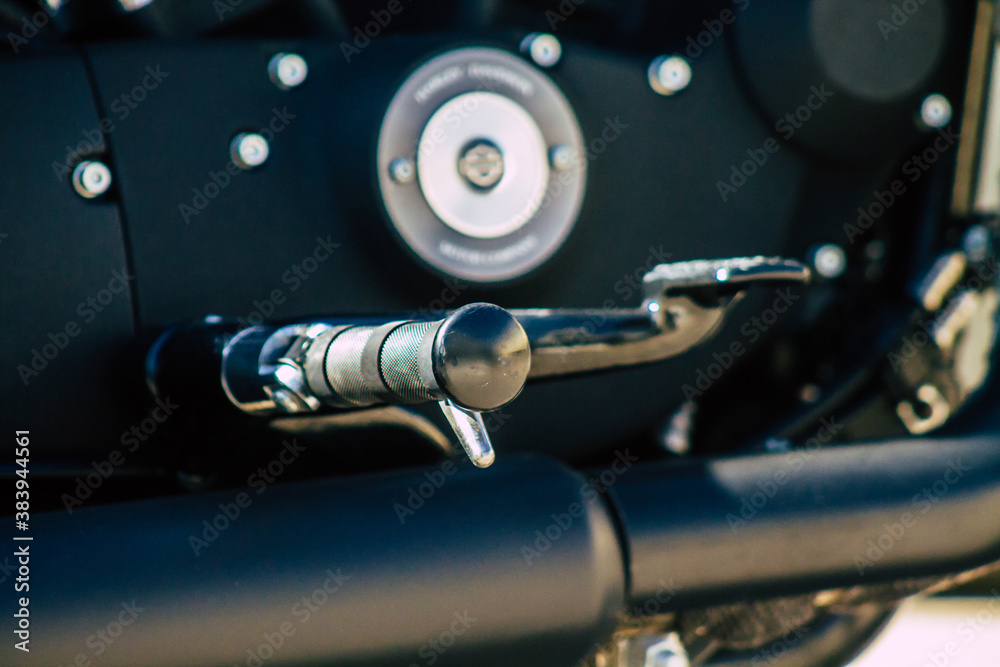 Fototapeta premium Closeup of a motorcycle parked in the streets of the city center of the metropolitan area
