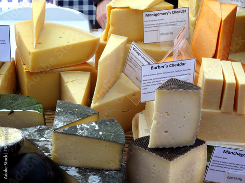 British cheeses on a farmers market stall in London, England, UK.