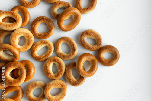 Pile of crispy cracknels isolated on white background, dessert for tea, baked dry bagels photo