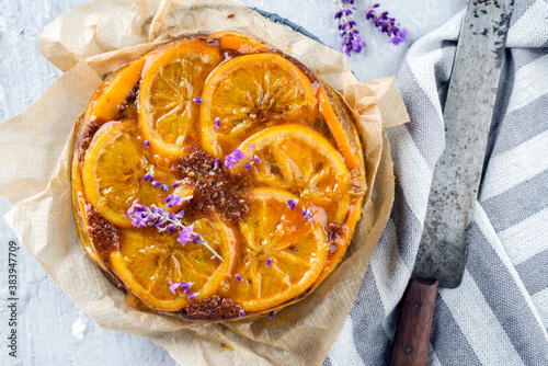 Traditional orange chocolate cake offered as top view on on a rustic grid photo
