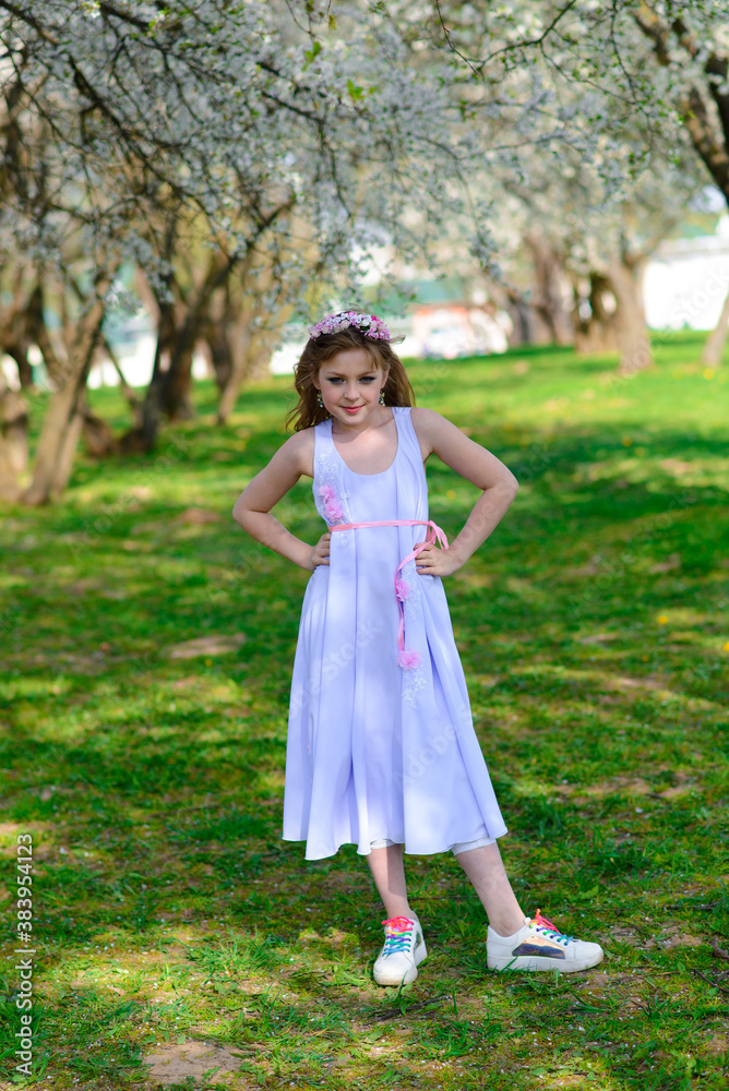 Pretty little girl in blooming apple tree garden on beautiful spring day Pretty little girl in blooming apple tree garden on beautiful spring day