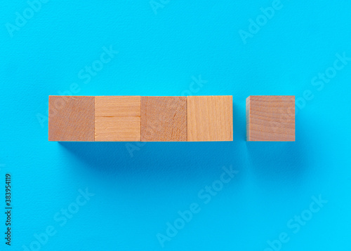 Fototapeta Naklejka Na Ścianę i Meble -  Top view of wooden toy blocks on blue