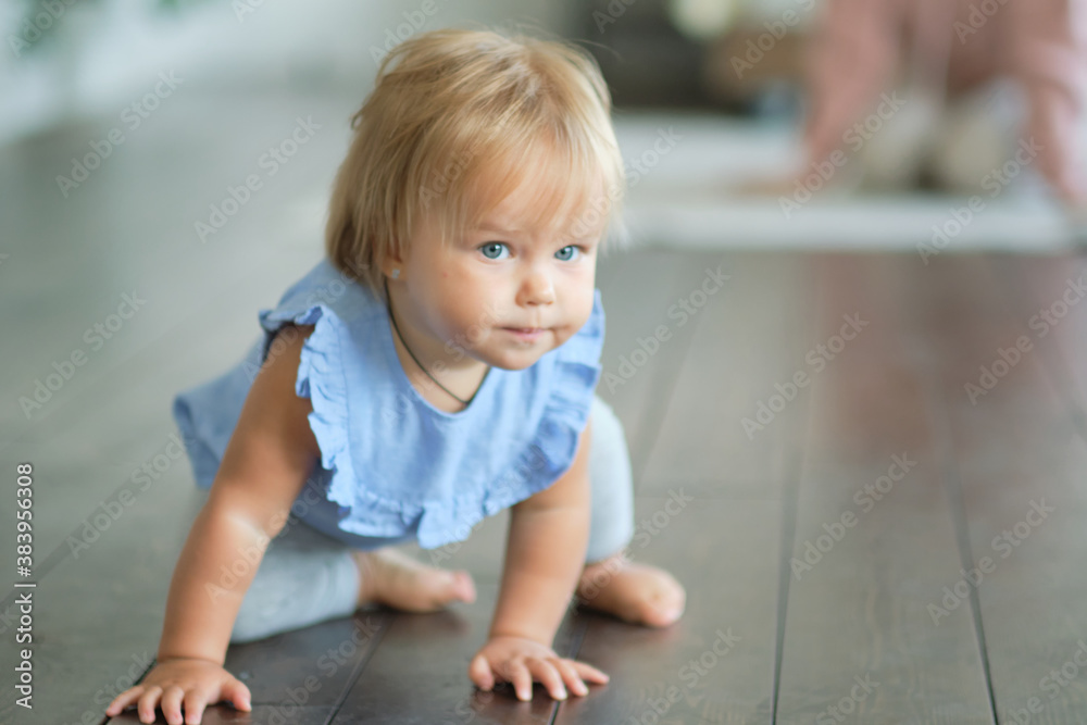 childhood, babyhood and people concept. happy little baby girl sitting on a wooden floor at home. childhood, babyhood and people concept. happy little baby girl sitting on a wooden floor at home.