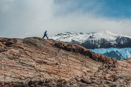 Man walking mountaing in front of Perito Moreno Glacier - Los Glaciares National Park. Patagonia Argentina.