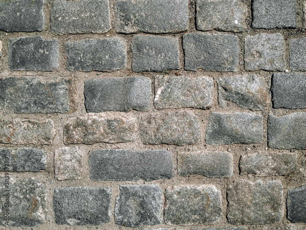 Texture of gray granite paving stones, top view. Background from natural block stone. Texture of gray granite paving stones, top view. Background from natural block stone.