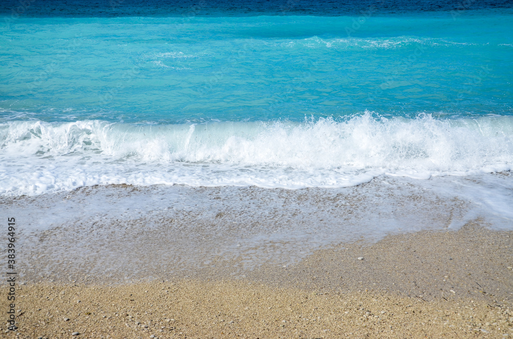 Waves crashing on beach. Waves breaking on the shore. Coastline. Beautiful sandy beach at summer. Ocean horizon. Turquoise water of Ionian Sea. Vacation holidays. Mediterranean coast. Deep blue sea. 
