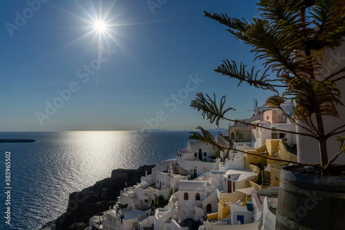 Panoramic view of Oia town in Santorini island with old whitewashed houses and traditional windmill, Greece. Greek landscape on a sunny day