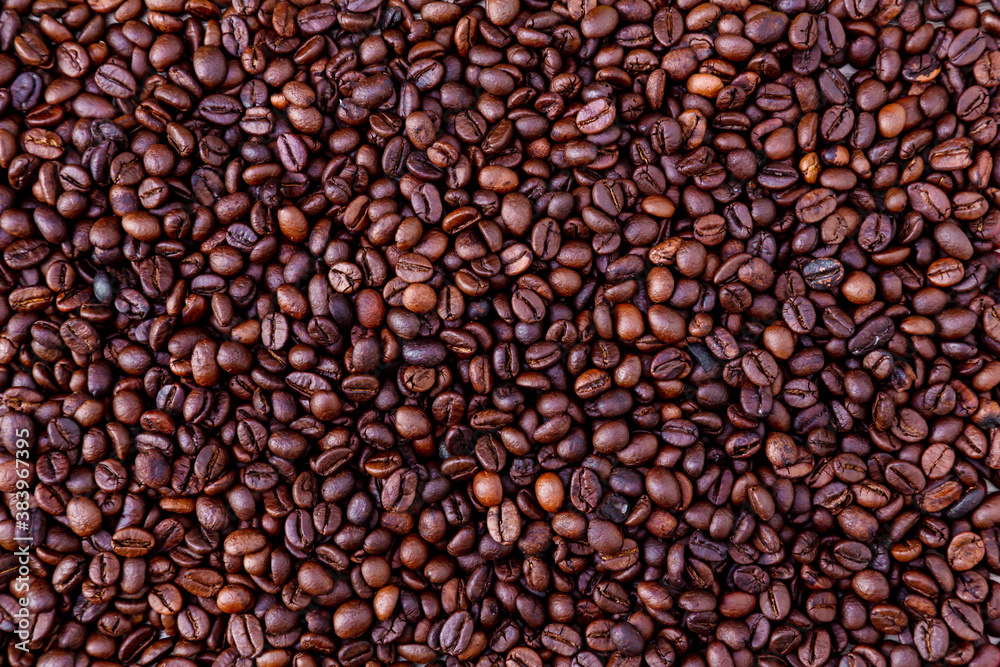 Freshly roasted coffee beans background. Coffee beans background. Background of roasted coffee beans. Freshly roasted coffee beans background. Coffee beans background. Background of roasted coffee beans.