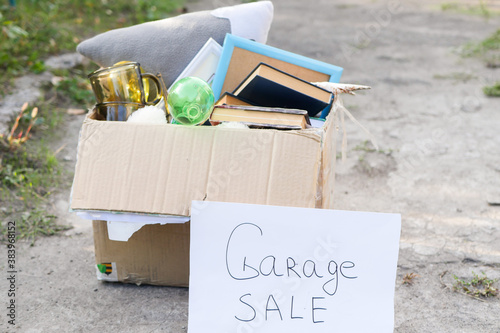 Garage sale sign. Old items in the box. Selling old stuff. Vintage market. Second hand.