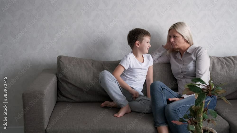 The son is talking to his mother. Mom listens carefully.