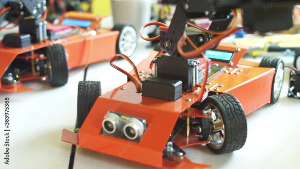 Crop teenager playing with modern robot in class Crop teenager playing with modern robot in class