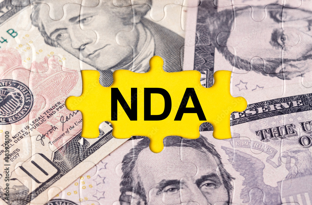 Puzzle with the image of dollars in the center of the inscription -NDA