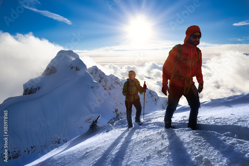Schilderij op canvas Fantasy Adventure Composite Image of Man and Woman Mountaineering up Snow with Mountain Peaks in Background