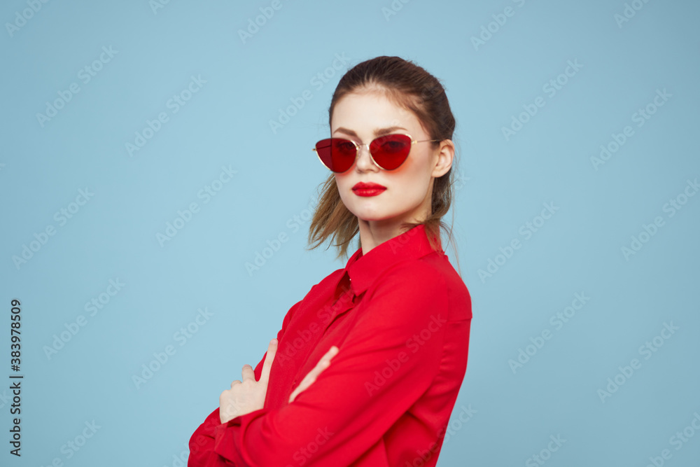 Woman with dark glasses red lips charm shirt studio blue background Woman with dark glasses red lips charm shirt studio blue background