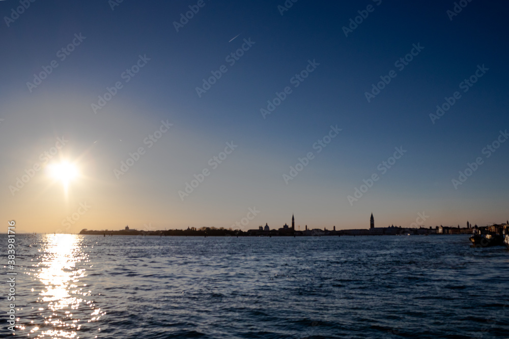 The sun sets over the Venetian lagoon and the distant San Giorgio Maggiore island
The sun sets over the Venetian lagoon and the distant San Giorgio Maggiore island