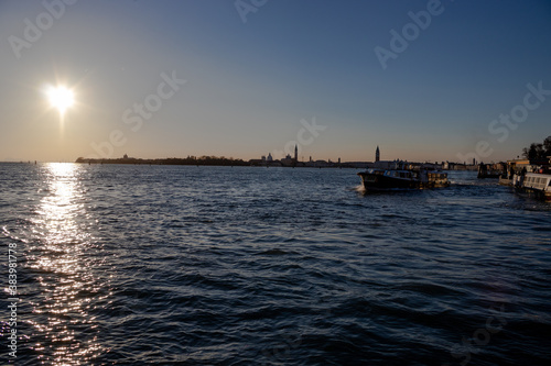 The sun sets over the Venetian lagoon and the distant San Giorgio Maggiore island 