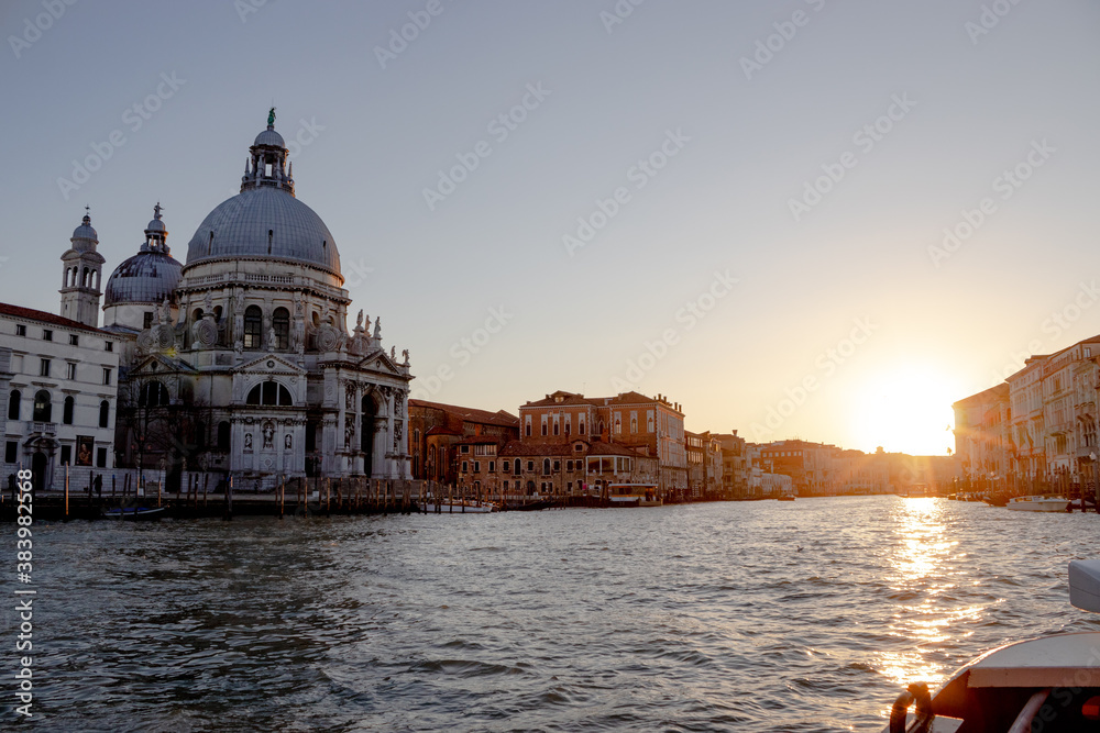 The sun sets leaving a pastel sky over Venice