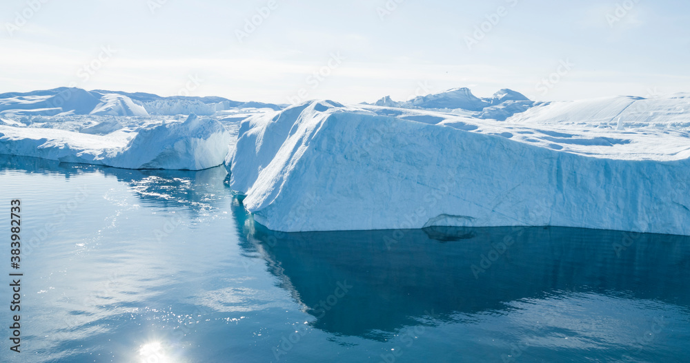 Iceberg aerial drone image - Global warming and climate change concept. Giant icebergs in Disko Bay on greenland in Ilulissat icefjord from melting glacier Sermeq Kujalleq Glacier, Jakobhavns Glacier.