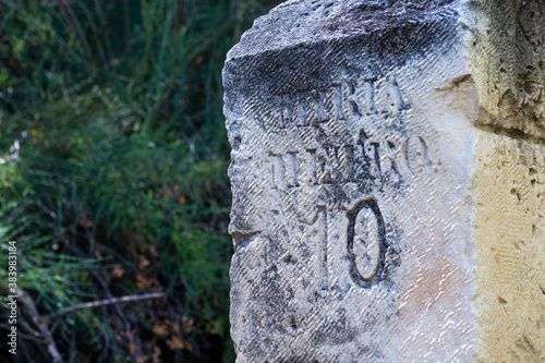 Old milestones exposed on the Bailen-Motril road (N-323) as it passes through La Cerradura de Pegalajar (Jaen-Spain) photo