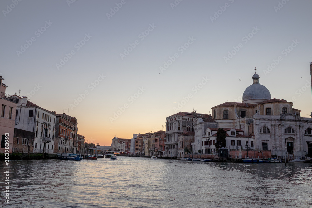 The setting sun creates a beautiful pastel evening sky over Venice

