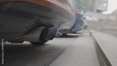 Traffic fumes. Exhaust pipe. Environmental pollution from cars. Black smoke from vehicles.
