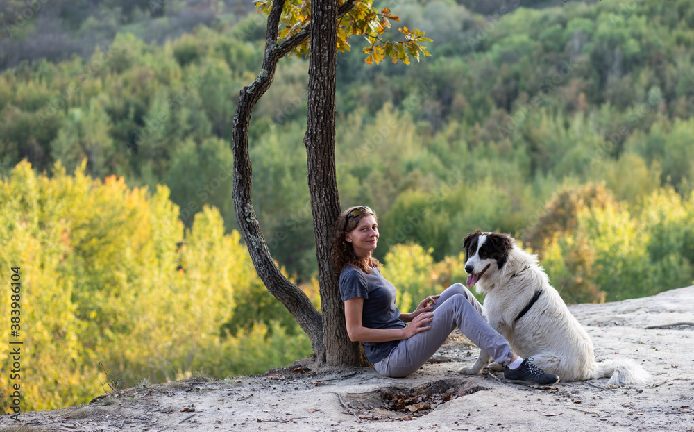 woman and dog enjoying the outdoors social distancing