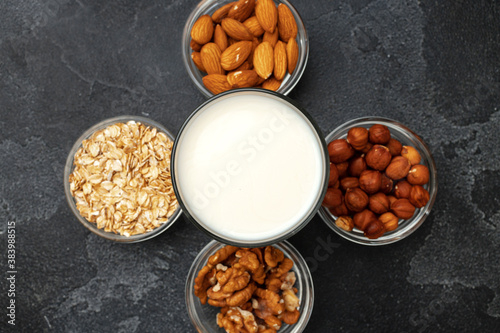 Vegan non dairy nut milk and heaps of different nuts top view