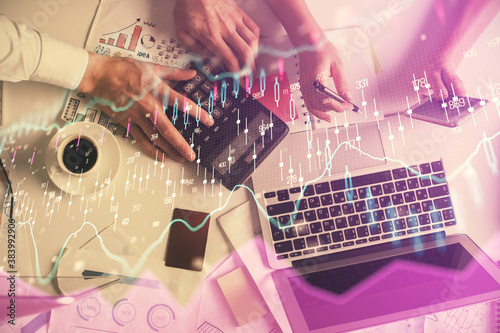 Double exposure of man and woman working together and financial chart hologram drawing. market analysis concept. Computer background. Top View.