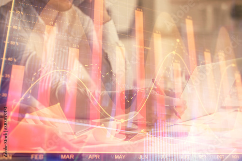 Wallpaper Mural Multi exposure of man and woman working together and financial chart hologram. Business concept. Computer background. Torontodigital.ca