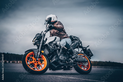Fototapeta Naklejka Na Ścianę i Meble -  biker rides on the road on a motorcycle