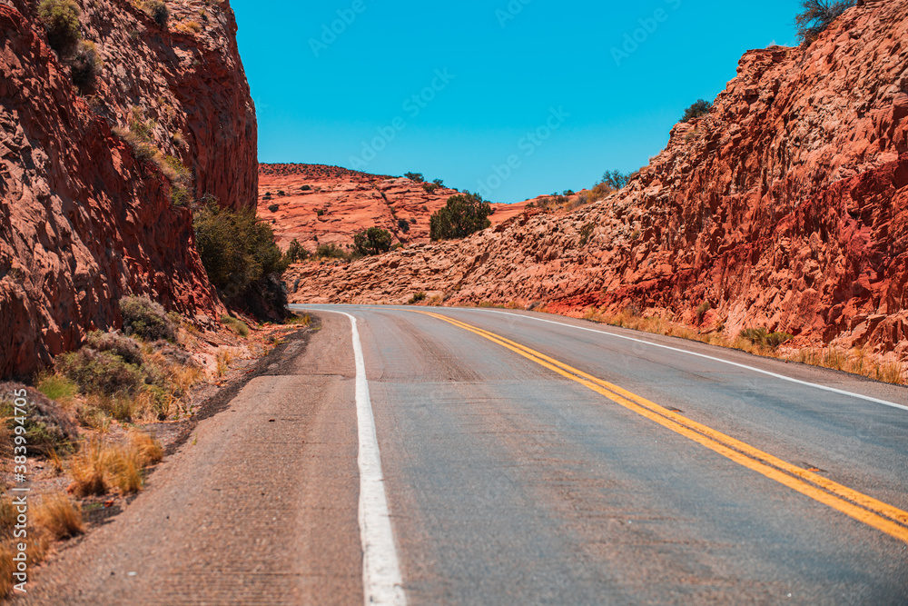 Landscape with rocks, bleu sky with asphalt road in the evening.