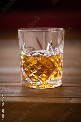 Whiskey glass on a table.