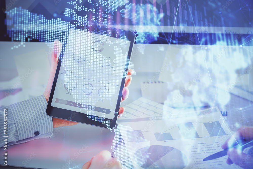 Double exposure of man's hands holding and using a digital device and forex graph drawing. Financial market concept. Double exposure of man's hands holding and using a digital device and forex graph drawing. Financial market concept.