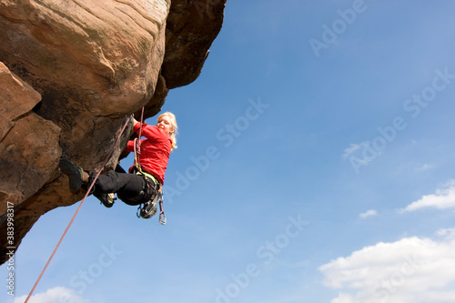 Young woman climbing a rock photo