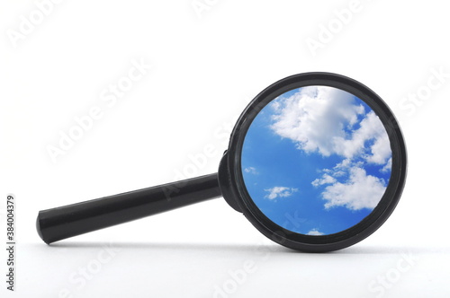 blue sky and magnifying glass photo