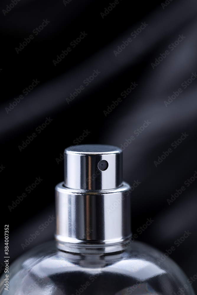 close up macro perfume spray bottle over dark luxury background. gloomy perfume container. copy space close up macro perfume spray bottle over dark luxury background. gloomy perfume container. copy space