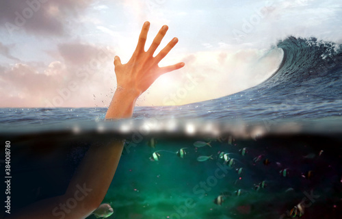 Fototapeta Naklejka Na Ścianę i Meble -  Hand of person drowning in water at sea