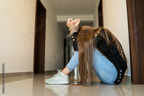 Konstfotografi Side view unknown caucasian woman or minor girl sitting in hall of hotel with ro