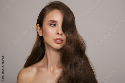Portrait of a mature woman with luxurious wavy hair. Hair and makeup