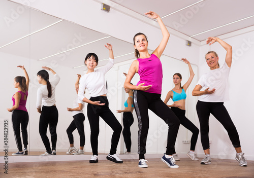 Women dancing aerobics at lesson in the dance class. High quality photo